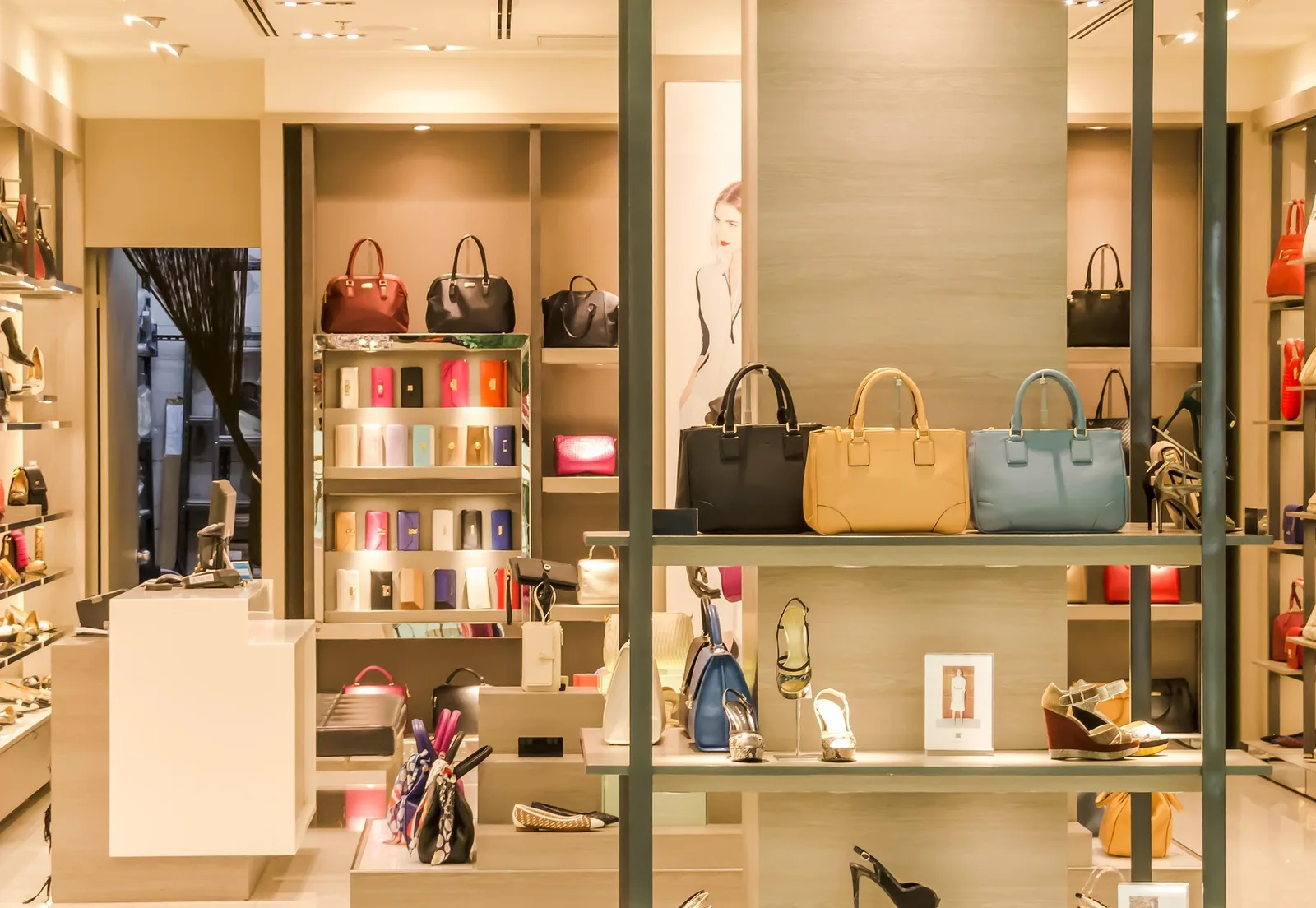 A boutique with handbags on lit shelves